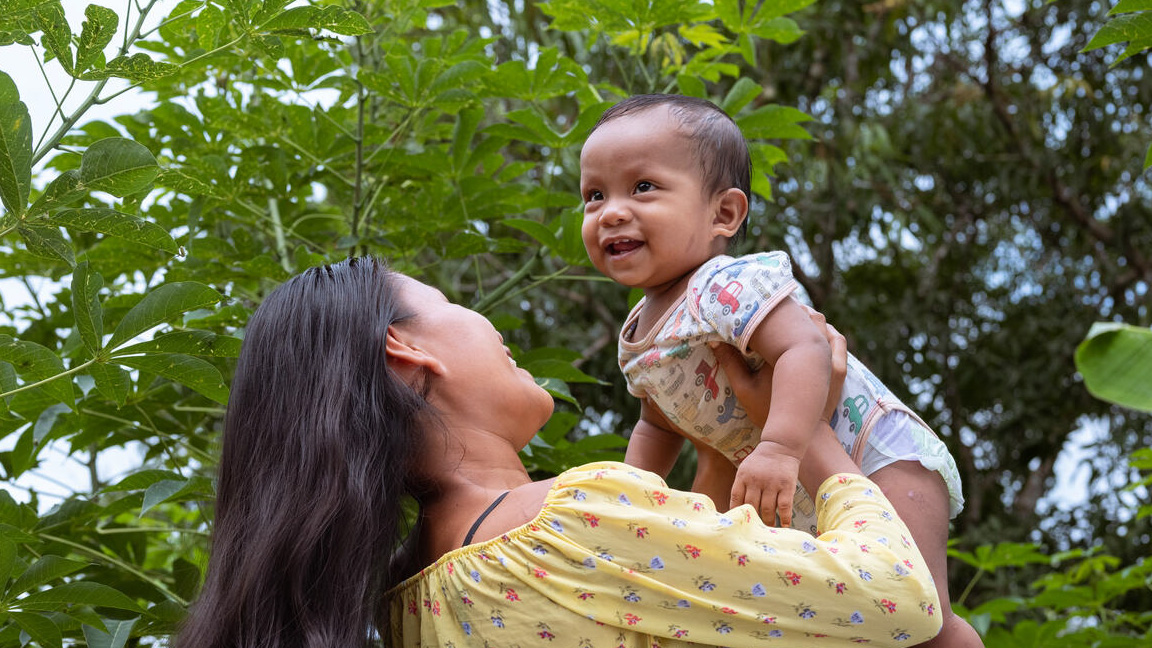 On 24 September 2022 in the Community of Lisboa, Loreto, Peru, Edreith Aricari, 18, holds her 11-month-old son Eric Chota after being treated by a UNICEF-supported health brigade for a stomach infection and fever. Since its difficult for his mother to take him to a health post, the arrival of the brigade was crucial for the health of Eric and other children.